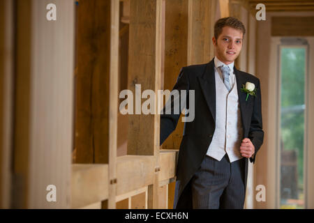 Getting married / Wedding day UK: a young man , the groom, dressed in a traditional formal morning suit about to get married. Stock Photo