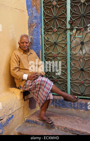 Old man sitting outside his home in the Blue City, Jodhpur, Rajasthan, India Stock Photo