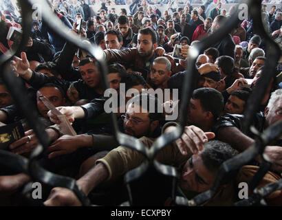 Rafah, Gaza Strip, Palestinians hoping to cross into Egypt, wait with their relatives at the border after Egypt opened the Rafah border crossing for the first time since the passage was closed on October 25. 21st Dec, 2014. The Rafah crossing was shut after Islamist militants in Egypt's adjacent Sinai region killed 33 members of the security forces. Credit:  Ashraf Amra/APA Images/ZUMA Wire/Alamy Live News Stock Photo