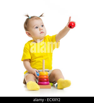 baby playing with colorful toy and pointing by finger isolated Stock Photo