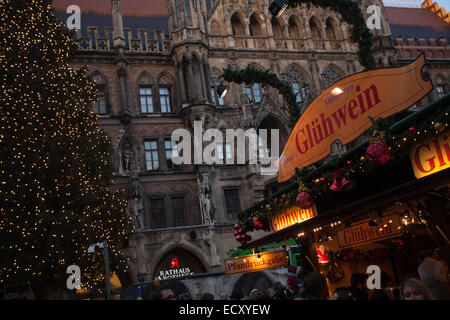 Munich Christmas Market stall selling Glühwein. In the background is the Munich town hall. Stock Photo