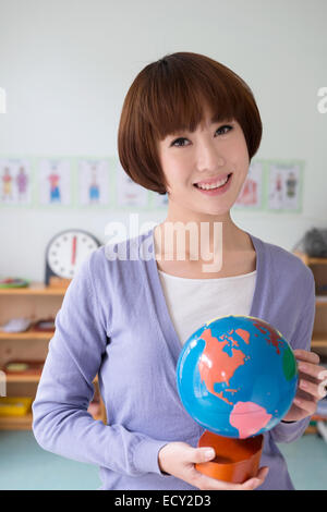 Young chinese woman preschool teacher smiling confident sitting with ...