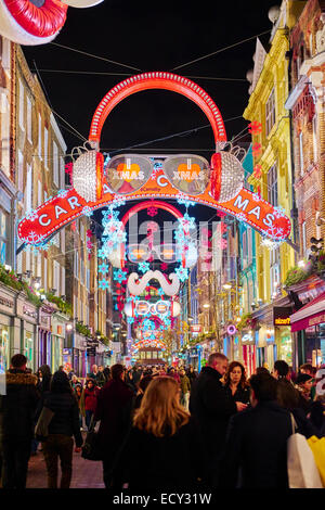 LONDON, UK - DECEMBER 20: Nighttime shot of busy Carnaby street with Christmas lights. December 20, 2014 in London. Stock Photo