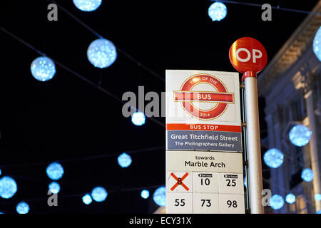 LONDON, UK - DECEMBER 20: Nighttime shot of London bus stop with Christmas lights in the background. December 20, 2014 in London Stock Photo