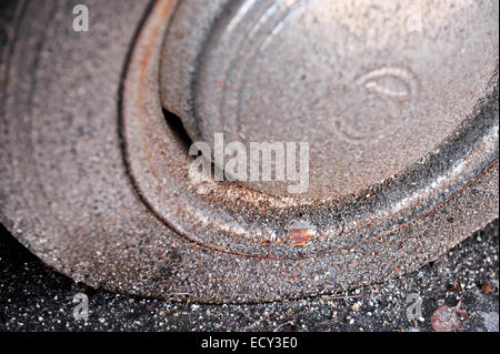 Abandoned car detail with a rusty rim and a flat tire Stock Photo