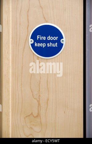 Fire door keep shut sign on an office door Stock Photo