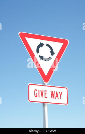 Traffic sign indicating a roundabout ahead - used in New Zealand and Australia Stock Photo