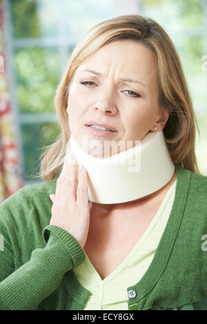 Woman Wearing Surgical Collar In Pain Stock Photo