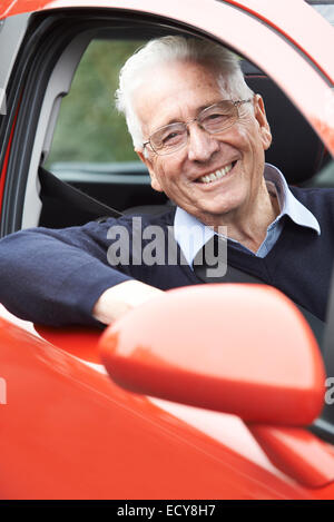 Portrait Of Smiling Senior Man Driving Car Stock Photo