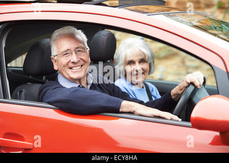 Portrait Of Smiling Senior Couple Out For Drive In Car Stock Photo