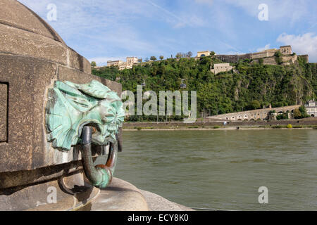 Ornate brass boat mooring ring on a quayside bollard beside River Rhine with Ehrenbreitstein fort. Deutsches Eck Koblenz Germany Stock Photo