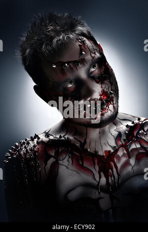 A creepy portrait of a pierced halloween moor with bloody body art. Stock Photo