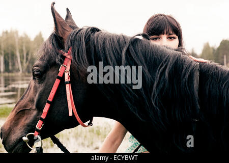 Caucasian woman with horse outdoors Stock Photo