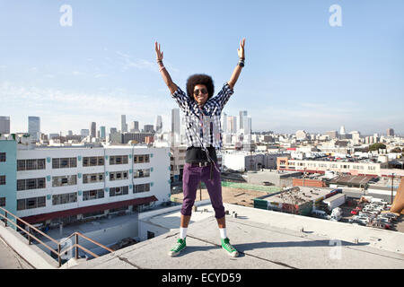 African American man and cityscape from urban rooftop Stock Photo