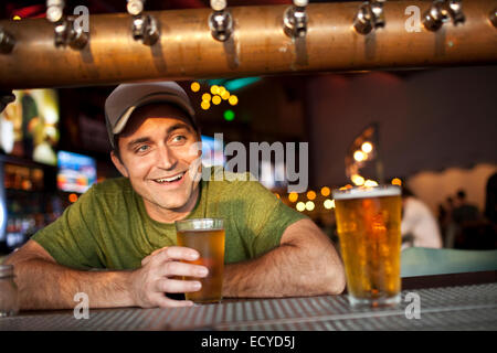Caucasian man drinking beer in bar