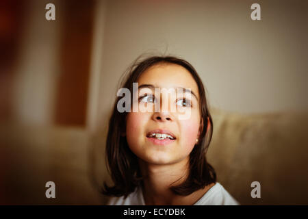 Mixed race girl looking up Stock Photo