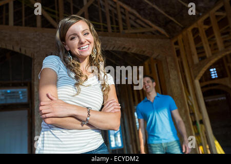 Caucasian woman smiling in house under construction