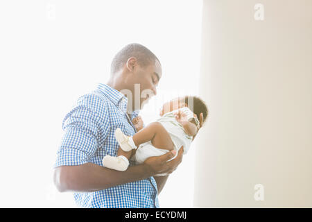 Father cradling baby son Stock Photo