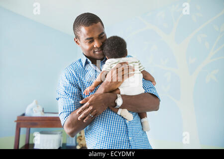 Father cradling baby son Stock Photo