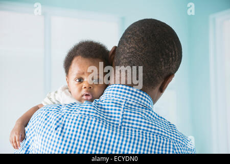 Father cradling baby son Stock Photo