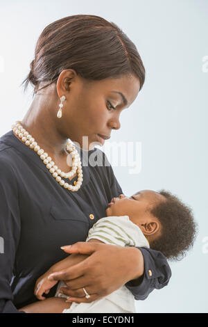 Mother cradling baby son Stock Photo