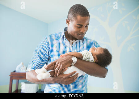 Father cradling baby son Stock Photo