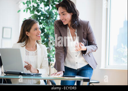 Hispanic businesswomen working together in office Stock Photo