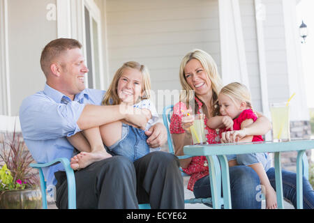 Caucasian family sitting on porch Stock Photo
