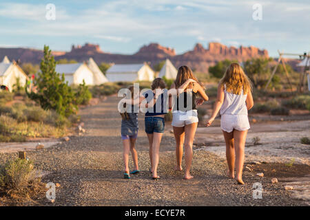 Children walking together on gravel path Stock Photo