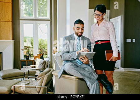 Business people using digital tablet together at home Stock Photo