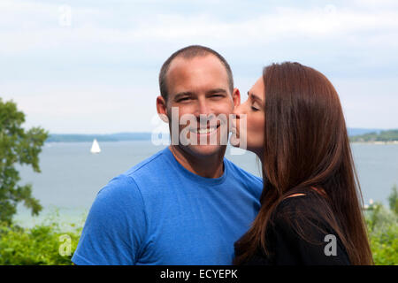 Caucasian woman kissing man outdoors Stock Photo