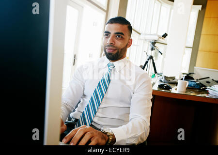 Middle Eastern businessman working at computer in office Stock Photo