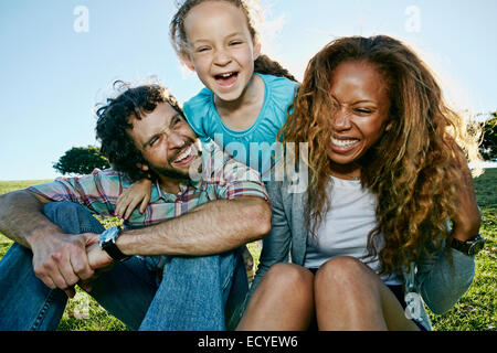Family playing together outdoors Stock Photo