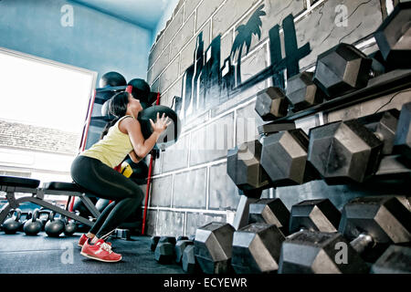 Hispanic woman exercising in gym Stock Photo