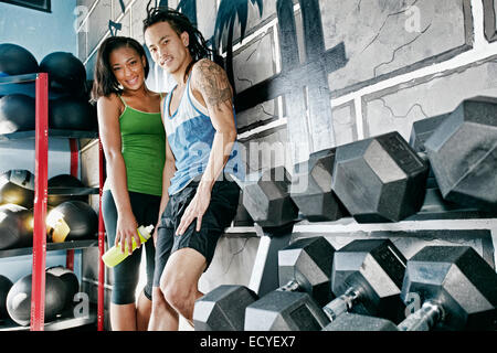 Couple smiling together in gym Stock Photo