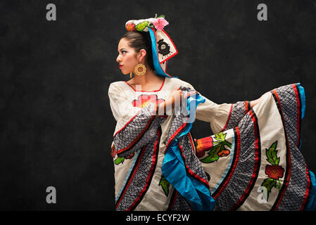 Hispanic teenage girl dancing in Sinaloa Folkloric dress Stock Photo