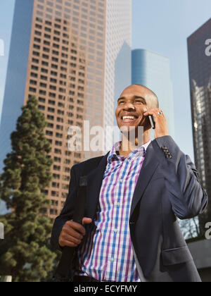 Black businessman talking on cell phone in city Stock Photo