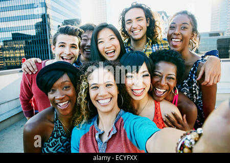Friends taking selfie on urban rooftop Stock Photo