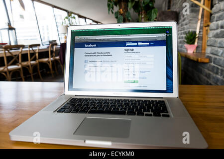 MacBook Pro Apple laptop on a desk with Facebook web page on display Stock Photo
