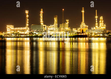 Oil Refinery Plant along river with tanker loading Stock Photo