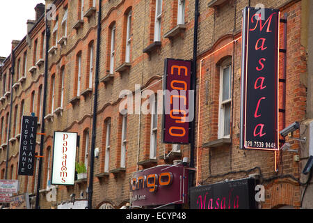 LONDON - OCTOBER 18TH: Restaurant signs on Brick lane on October 18th, 2014 in London, england, uk. Brick lane is a culinary att Stock Photo