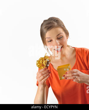Surprised girl opening the gift box on white background Stock Photo