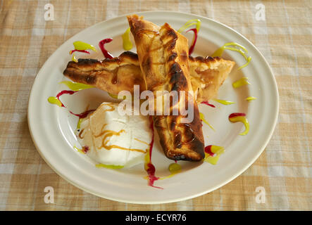 strudel and ice cream with jam decoration on white plate Stock Photo
