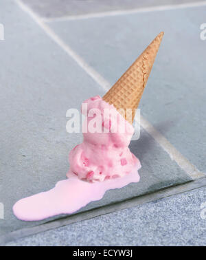 double dip pink bubble gum ice cream cone melting upside down on a sidewalk Stock Photo