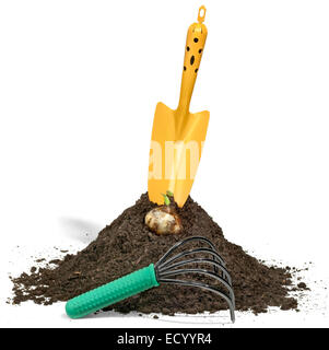 trowel in dirt with rake Stock Photo