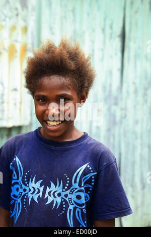 EPI,VANUATU-OCTOBER 5, 2014: Pretty girl poses for the photographer at the entrance to her home on October 5, in Nikaura-Vanuatu Stock Photo