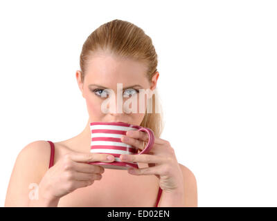 beautiful young woman drinking from a large mug of tea or coffee Stock Photo