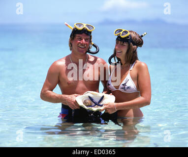 Couple with snorkeling gear in sea, Beachcomber Island Resort, Beachcomber Island, Mamanuca Islands, Republic of Fiji Stock Photo