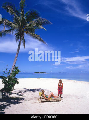 Young women on tropical beach, Beachcomber Island Resort, Beachcomber Island, Mamanuca Islands, Viti Levu, Republic of Fiji Stock Photo