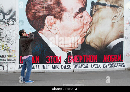 Tourist taking photos to Berlin wall, Germany Stock Photo